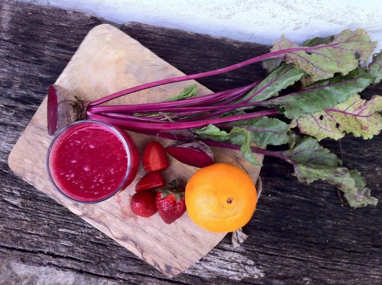 Glass of fresh Beet Strawberry Juice for energy and blood sugar stability before morning workouts.
