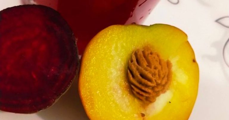 Glass of Beet Peach Orange Juice on a morning table, offering a refreshing energy boost and blood sugar support.