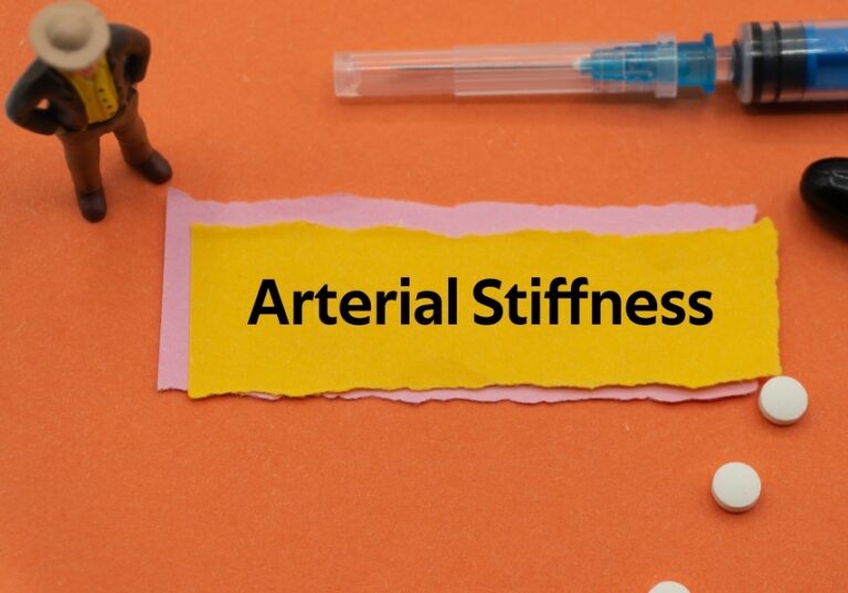 Arterial stiffness warning signs — yellow label with medical items including syringe and pills representing the 6 early signs of arterial stiffness you should never ignore.