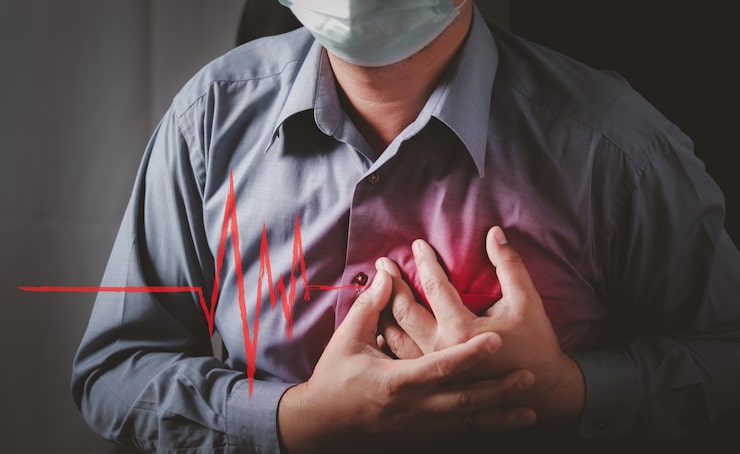 Man clutching his chest in pain with a red heartbeat ECG graphic overlay, illustrating chest pain during a heart attack caused by coronary thrombosis.
